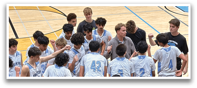 A group of young men are gathered on a basketball court, engaged in a conversation. AI generated content