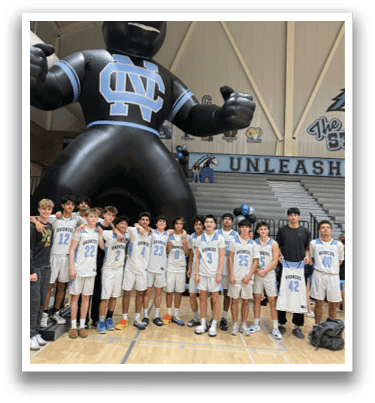 A group of young men pose for a photo in front of a large inflatable mascot. AI generated content