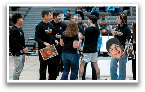 A group of people are standing on a basketball court, some of them holding balloons. AI generated content