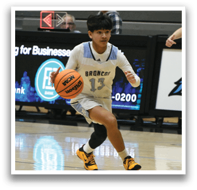 A basketball player wearing a blue shirt and white shorts is holding a basketball. AI generated content