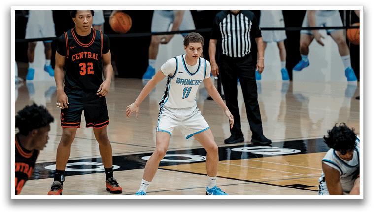 A group of basketball players on a court, with one player wearing a white jersey. AI generated content