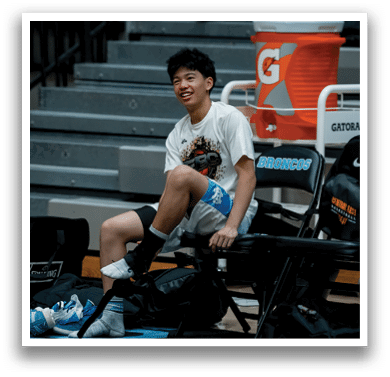 A man sits on a bench with a backpack and a bottle of Gatorade. AI generated content