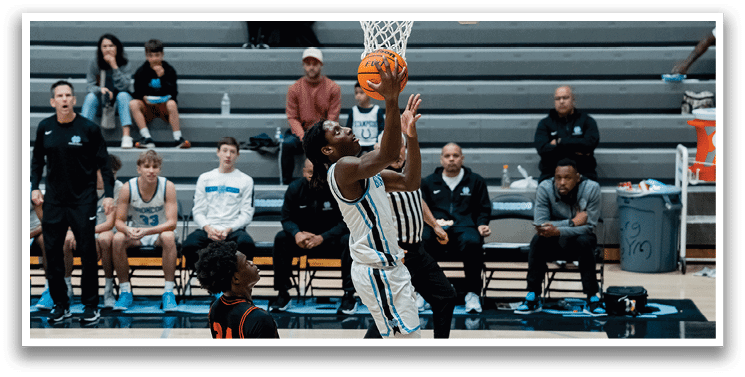 A basketball player leaps into the air to block a shot. AI generated content