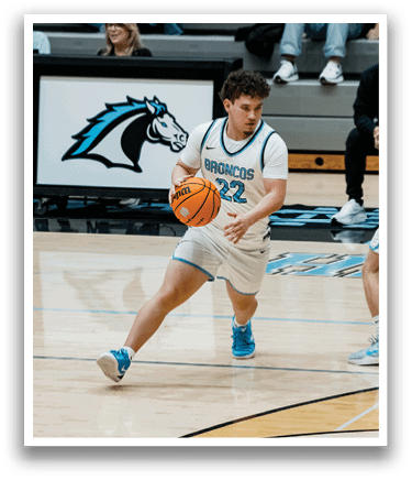 A basketball game is taking place with players on the court. One player is holding a basketball and is about to shoot it. There are several other players on the court, some of whom are wearing uniforms. A crowd of people is watching the game from the stands. AI generated content