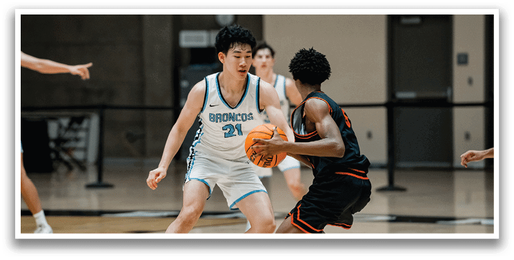 Two men playing basketball, one with a ball and the other trying to block him. AI generated content