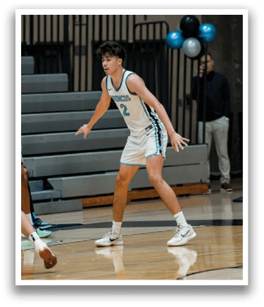 Two men playing basketball on a court. One player is wearing a blue shirt and white shorts. AI generated content