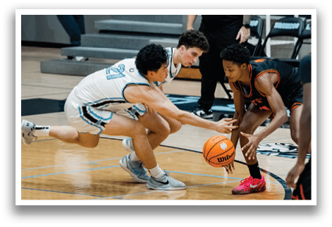 A group of men playing basketball, one man is trying to get the basketball while another man is trying to stop him. AI generated content