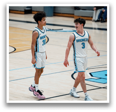 Two young men wearing basketball uniforms are walking on a basketball court. AI generated content