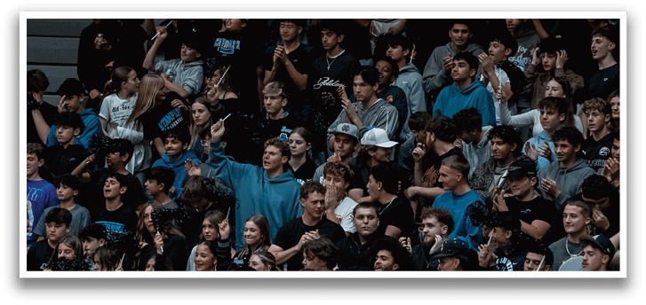 A large crowd of people are watching a game, with some of them holding up their cell phones. AI generated content