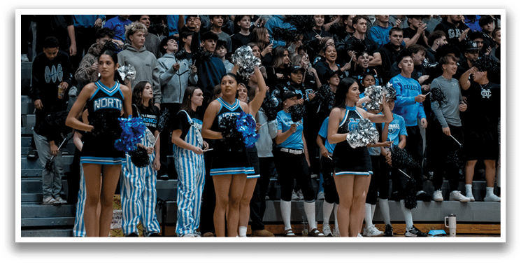 A basketball player wearing a blue uniform is running on the court while holding a basketball. AI generated content