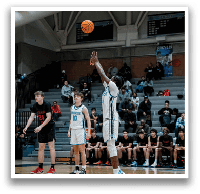 A basketball game is taking place with a player in the air attempting to shoot the ball. The crowd is watching intently as the game unfolds. AI generated content