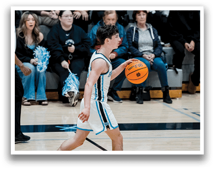 A boy is holding a basketball while walking on a court. AI generated content