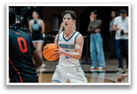A basketball player in a white uniform holds a basketball on a court. AI generated content