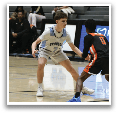 Two men playing basketball on a court. One man is wearing a black shirt and the other is wearing a white shirt. AI generated content