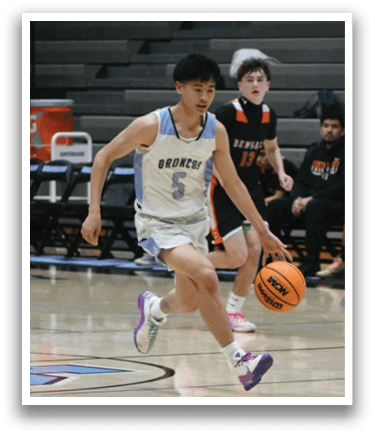 A basketball player in a white uniform is dribbling a ball on the court. AI generated content