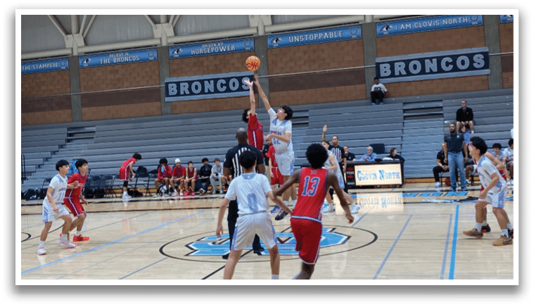 A group of young men playing basketball in a gym. AI generated content