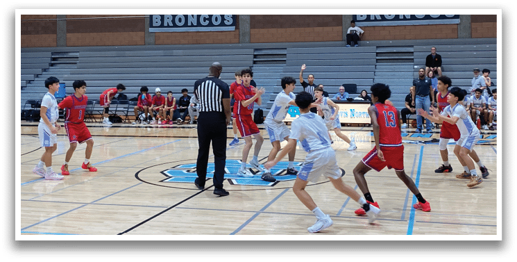 A group of young men playing basketball in a gym. AI generated content
