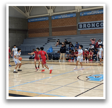 A group of young men playing basketball in a gym. AI generated content