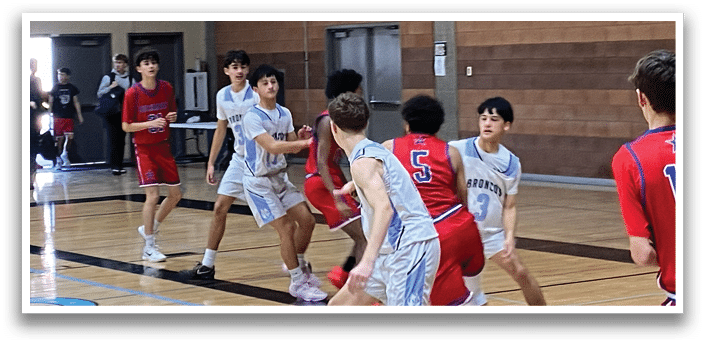 A group of young men playing basketball in a gym. AI generated content