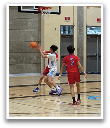 A group of young men playing basketball in a gym. AI generated content