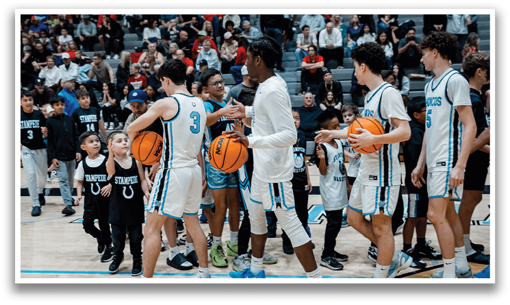 A group of young men and boys are holding basketballs on a court. AI generated content