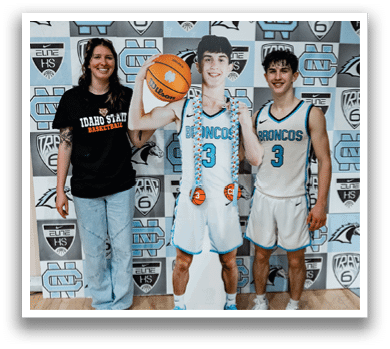 Two people pose with a cutout of a basketball player. AI generated content