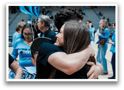 A man and woman hugging each other in a gymnasium. AI generated content