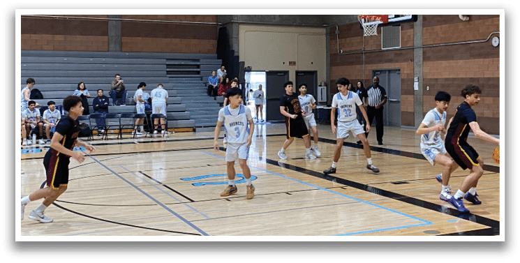A group of young men playing basketball in a gym. AI generated content