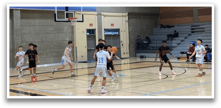 A group of young men playing basketball in a gym. AI generated content