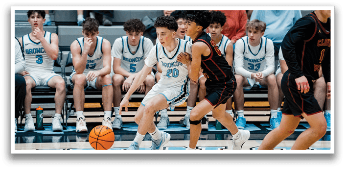 A group of young men playing basketball, with one player holding the ball and others running towards him. AI generated content