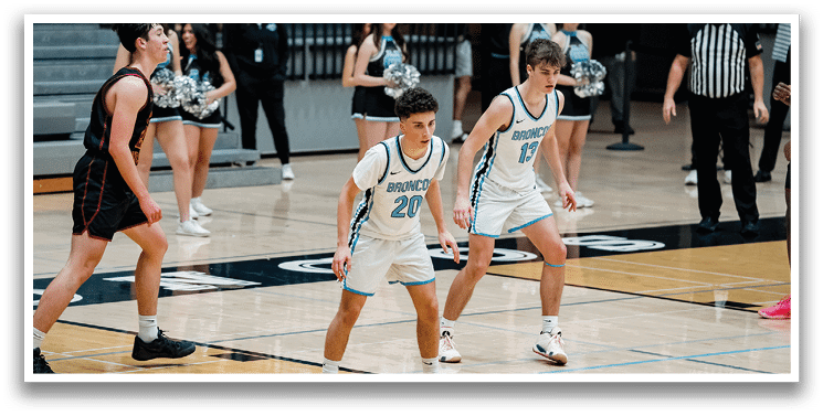 A group of young men playing basketball on a court. AI generated content