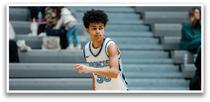 A young man wearing a basketball jersey is running on a basketball court. AI generated content