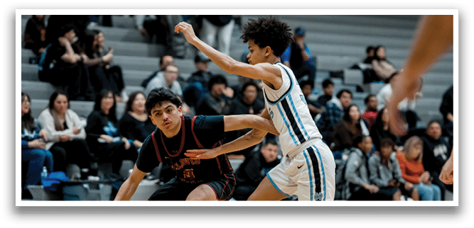 Two basketball players are running for the ball, with one player in a red jersey and the other in a blue jersey. The players are both wearing shorts and are actively engaged in the game. AI generated content