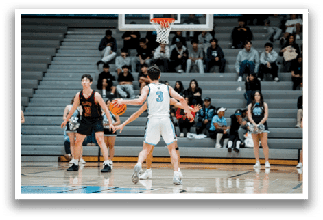 A basketball game is in progress with a player holding the ball and getting ready to shoot. The game is being watched by a crowd of people sitting on benches. AI generated content