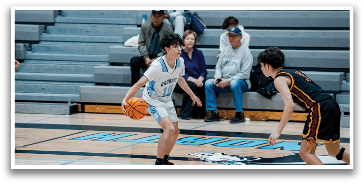 A group of young men playing basketball on a court. AI generated content