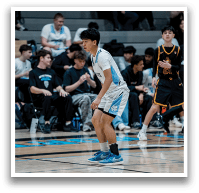 A group of young men playing basketball on a court. AI generated content