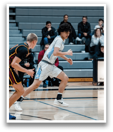 A group of young men playing basketball on a court. One player is holding a basketball. AI generated content