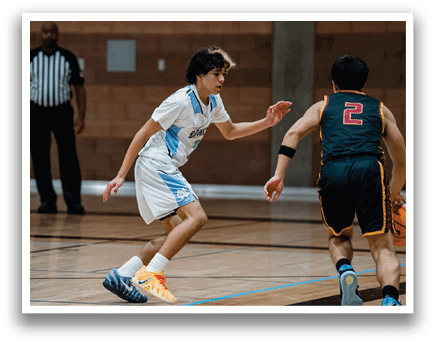 Two young men are playing basketball on a court. One player is holding a basketball and the other is running towards him. AI generated content