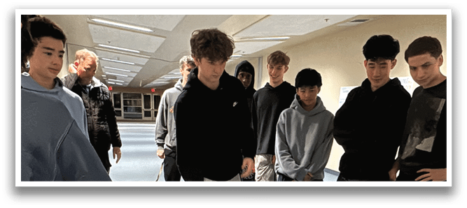 A group of young people are posing for a picture, some of them holding up game controllers. AI generated content