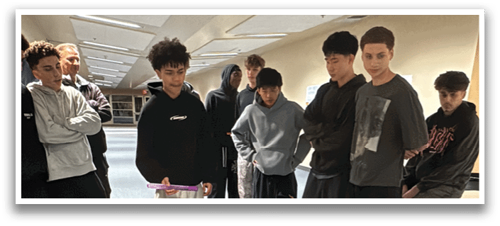 A group of people are gathered around a table with a row of books on it. AI generated content