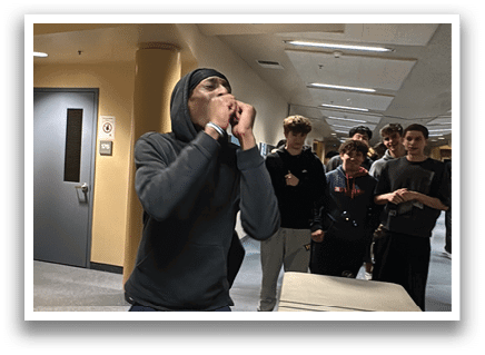 A man wearing a hoodie is standing in a hallway and talking on a cell phone. AI generated content