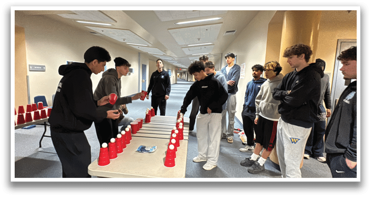 A group of people are playing a game of beer pong in a room. AI generated content