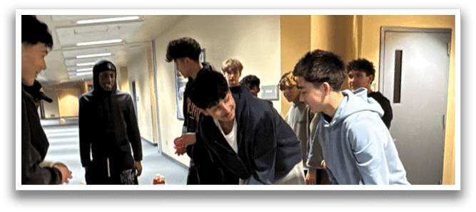 A group of people are playing a game of beer pong in a room. AI generated content