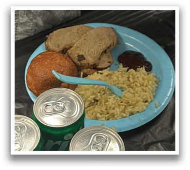 A plate of food is on a table with a fork and a can of soda. AI generated content