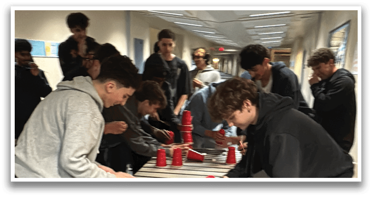 A group of people are playing a game using red cups on a table. AI generated content