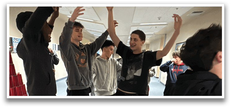 Four people are standing in a room, holding their arms up. AI generated content