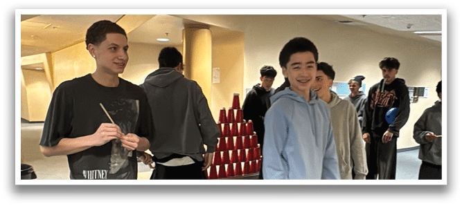 A group of people are standing in a room, playing a game with a Nintendo Wii controller. AI generated content