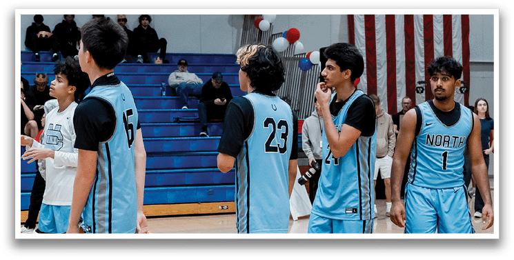 A group of young men wearing blue uniforms are standing on a basketball court. AI generated content