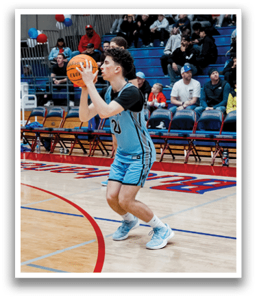 A basketball player in a blue uniform is holding a basketball on a court. AI generated content