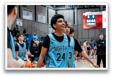 A group of young men are playing basketball on a court. AI generated content